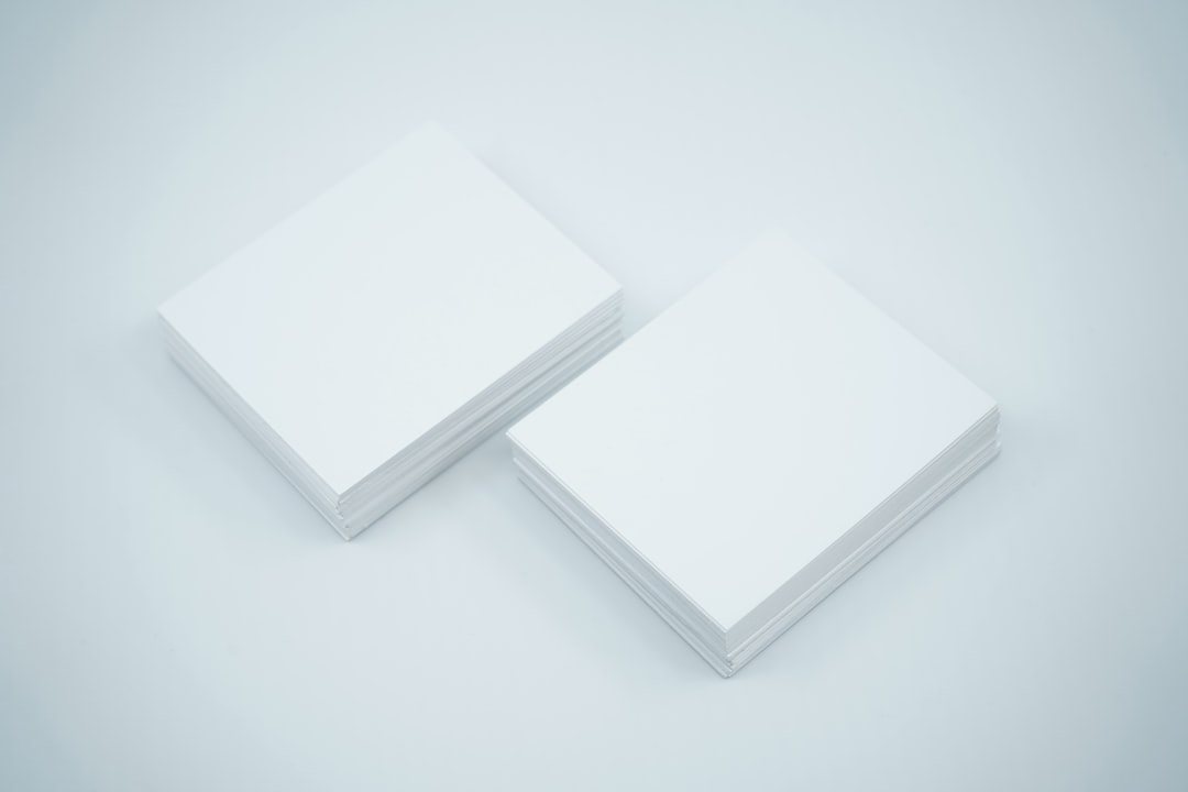 Blank white business cards on a light grey background showcase their crisp edges and smooth surfaces, ideal for professional use, customization, and corporate promotions.
